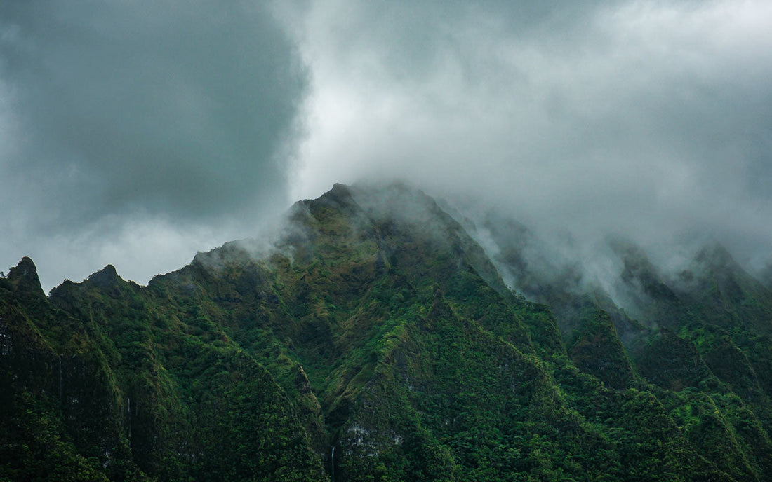 Image of the Ko'olau mountain range of O'ahu, Hawai'i enveloped in clouds in a mood scene of tranquility